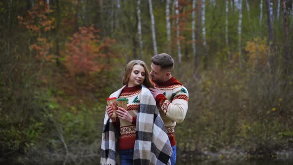 Romantic couple on autumn forest background. 