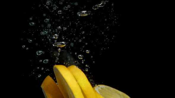 The Circle of an Orange Falls Into the Water