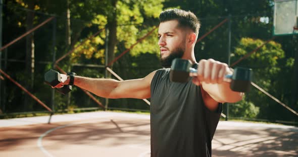 Fit Man Working Out with Dumbbells