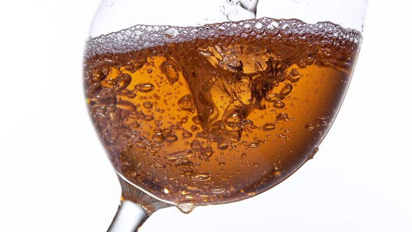 Pink Wine being poured into Glass, against White Background, Slow motion