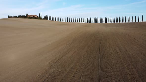 Famous Farmhouse and Cypress Trees Road in Rolling Hills of Val d'Orcia Tuscany