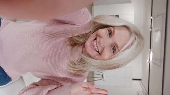 Vertical Video of Happy Senior Woman on Selfie Video Conference Saying Hello Facing Camera Smiling