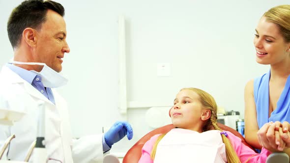 Dentist interacting with young patient