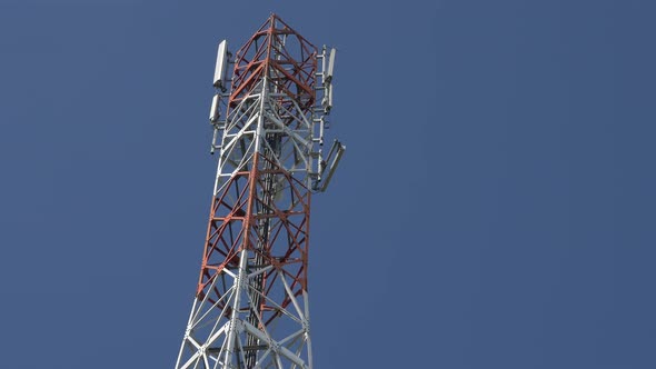 Telecommunication tower construction against blue sky 4K 2160p UHD video - Modern antenna system out