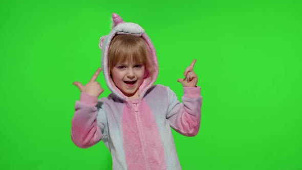 Little Child Girl Smiling Waving Greeting Hello or Bye with Hand in Unicorn Pajamas on Chroma Key