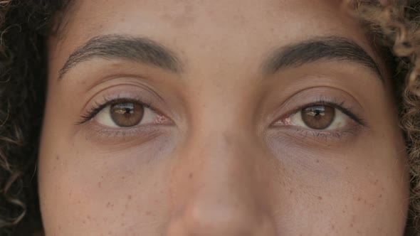 Close Up of Blinking Eyes of African Woman Looking at Camera