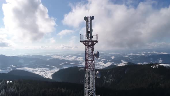 Flying Over Radio Communications Tower, Mountain Snow Covered Winter Landscape