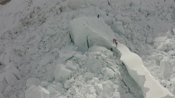 Group of People Climbing Mount Everest Huge Mountain Covered in Snow