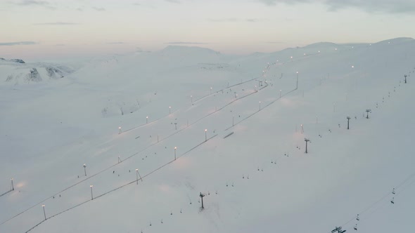 Ski Resort Chairlifts in Blafjoll, Iceland - Aerial Flyover Above Snowy Slopes