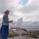Middleaged European Woman Artist Paints a Seascape with an Original View of the Sea - VideoHive Item for Sale