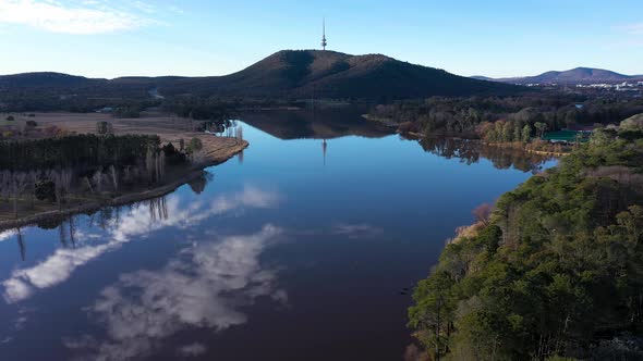 Beautiful Canberra Lake Burley Griffin aerial cloud reflection camera tracking backwards, with Telst