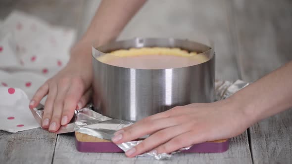 Woman Pastry Chef Prepares Berry Mousse Cake in the Kitchen