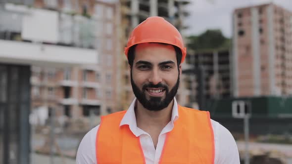 Portrait of Construction Worker on Building Site Smiling at the Camera