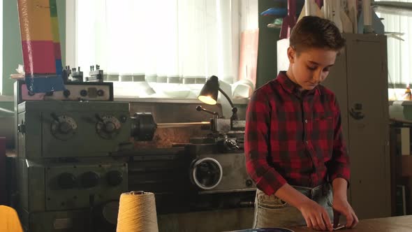 Teenage Boy Making a Paper Airplane