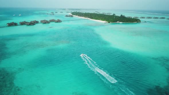 Aerial View of Jet Ski Racing on a Crystal Clear Turquoise Water in Maldives