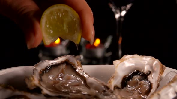 Lemon Juice Dripping on Fresh Oysters