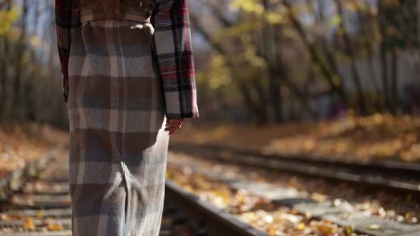 Lady is Walking and Admiring Nature in Sunny Autumn Day Rear View