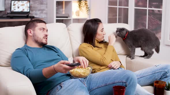 Couple Relaxing Watching a Movie on Tv