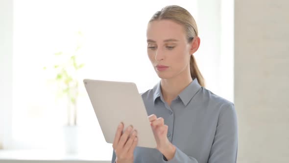 Upset Woman Reacting to Loss on Tablet