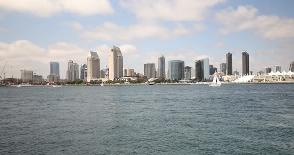 San Diego, California from a boat with the city center in the background and passing boats.