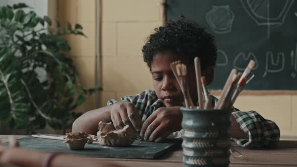 Black Boy Making Crafts of Clay