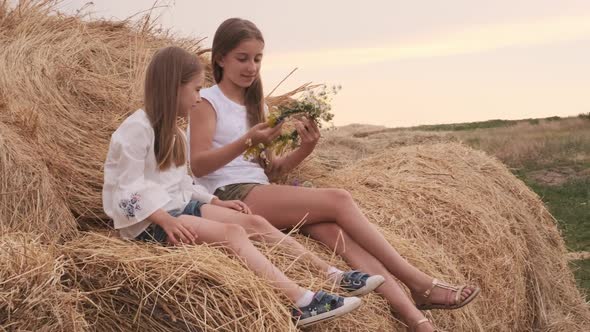 Girls Sitting on Hay