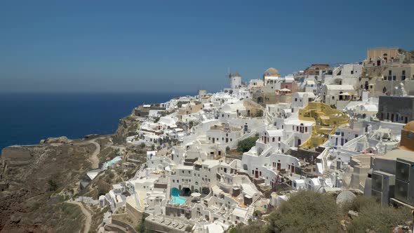 Iconic view over Oia Santorini with windmills and white houses, Greece