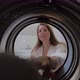 Woman Opens Door of Washing Machine Puts in Dirty Clothes and Takes Out Clothes - VideoHive Item for Sale