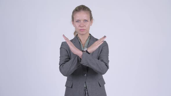 Young Serious Blonde Businesswoman Showing Stop Gesture Using Arms