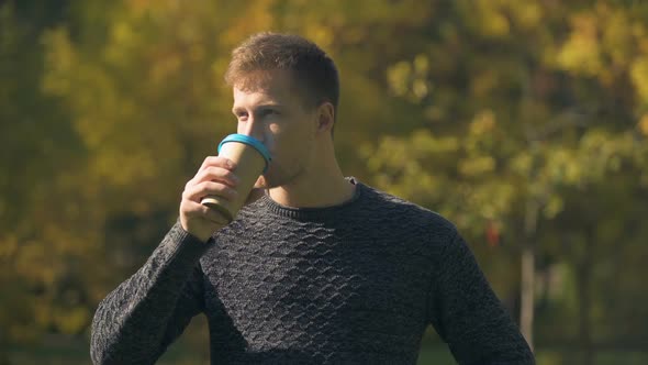 Pensive Male Drinking Coffee in Autumn Park, Thinking About Start Up, Goals