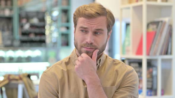 Portrait of Pensive Young Man Thinking of Ideas 