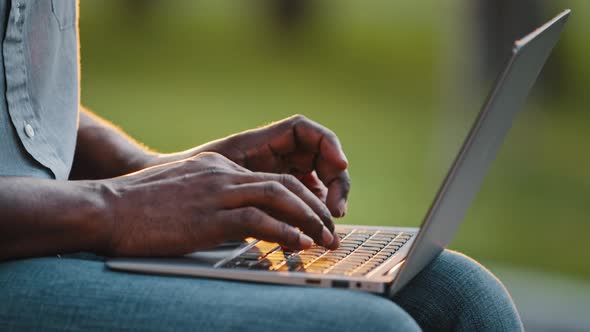 African Man Professional Busy Worker Freelancer Blogger User Typing on Laptop Sit Outdoor Close Up