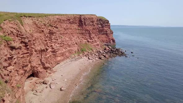Aerial, flying along red sandstone and mudstone cliffs of Budleigh Salterton, Devon, UK, a UNESCO Wo