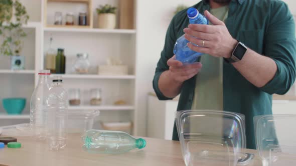 Unrecognizable Man Sorting Plastic Waste