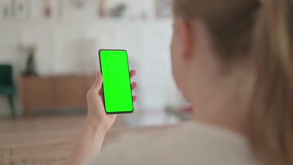 Rear View of Beautiful Woman Using Smartphone with Green Chroma Screen