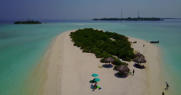 Wide angle overhead clean view of a white paradise beach and aqua blue ocean background in best qual