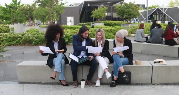 Diverse business people doing lunch break outdoor from office building