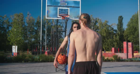 Basketball Players Approach Each Other to Hold Competition