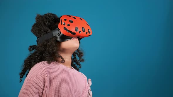 Cute Girl Plays Video Game with Virtual Reality Headset