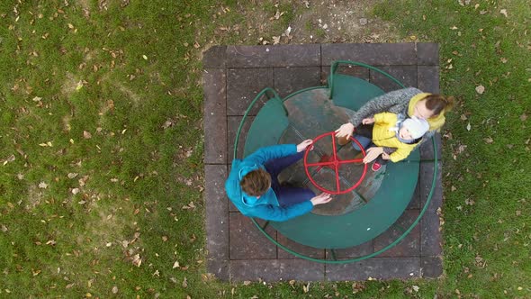 Aerial view of family spinning at merry-go-round, Zagreb, Croatia.