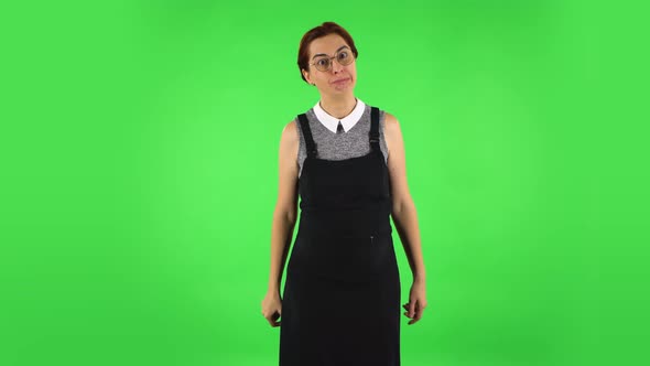 Funny Girl in Round Glasses Is Making Funnys Faces. Green Screen