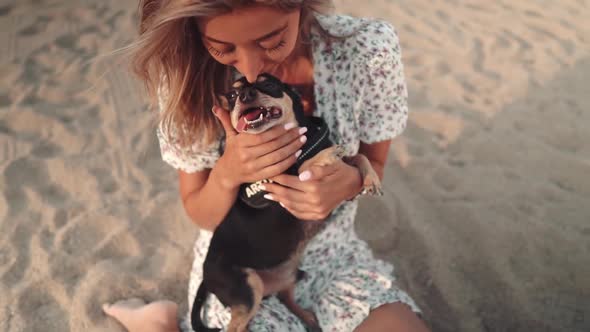 Small Dog Named Artur with Owner, Young Woman, Playing on the Beach