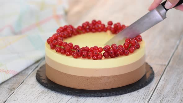 Cutting a Triple Chocolate Mousse Cake with Red Currant