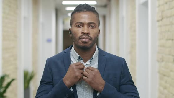 Portrait of Confident African American Businessman Posing in Office Corridor. Handsome Young Man in