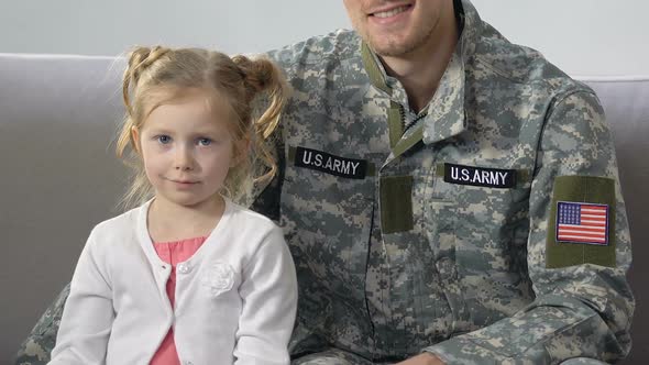 American Serviceman Hugging Cute Daughter Holding National Flag, Patriotism