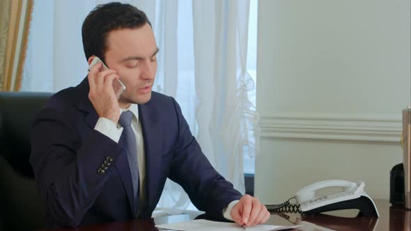 Young Serious Businessman Take a Phone Call, Having a Conversation and Getting Pensive