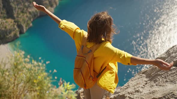 Slow Motion Woman Tourist with Blowing Hair Enjoying Sea Coast View From High Cliff Over Bay Summer