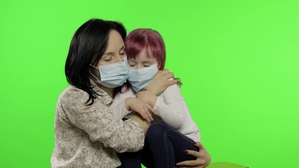 Sick Mother Hug Daughter in Medical Mask. Coronavirus Concept. Family Quarantine