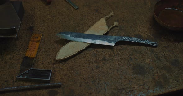 Handmade Steel Knife and Leather Scabbard on Table of Old Craft Workshop Closeup View  Prores