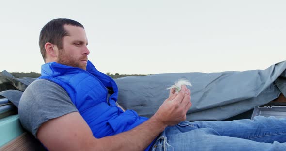 Man Looking at Bait While Travelling in Motorboat 4k